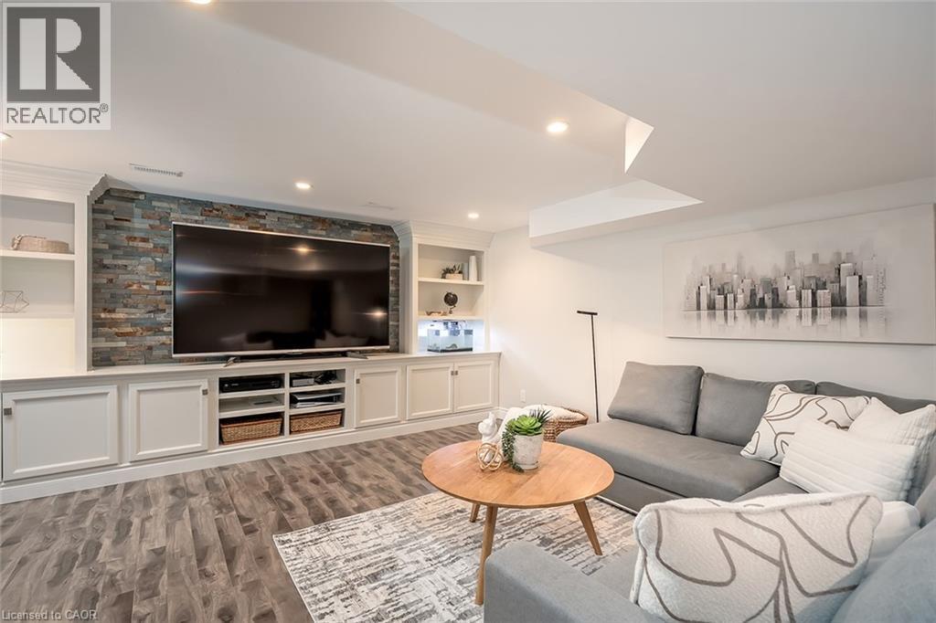 Living room with built in shelves, light wood-style floors, and recessed lighting - 4226 Dunvegan Road, Burlington, ON - Indoor Photo Showing Living Room