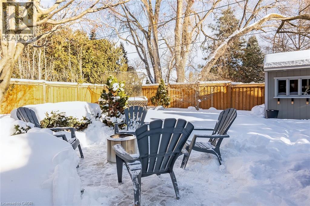 Snow covered patio with a fenced backyard - 4226 Dunvegan Road, Burlington, ON - Outdoor With Deck Patio Veranda