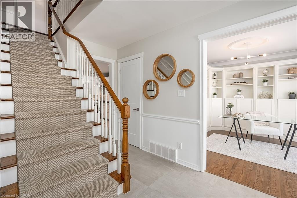 Staircase with baseboards and wood finished floors - 4226 Dunvegan Road, Burlington, ON - Indoor Photo Showing Other Room