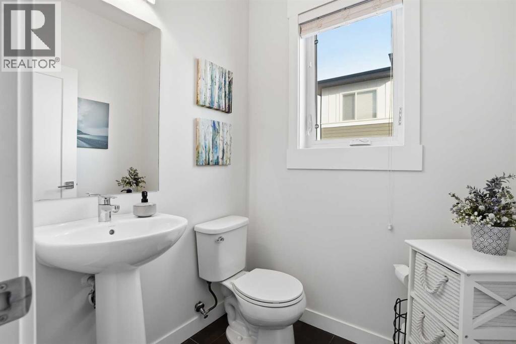 Main floor 2 pc bathroom - 70, 111 Rainbow Falls Gate, Chestermere, AB - Indoor Photo Showing Bathroom