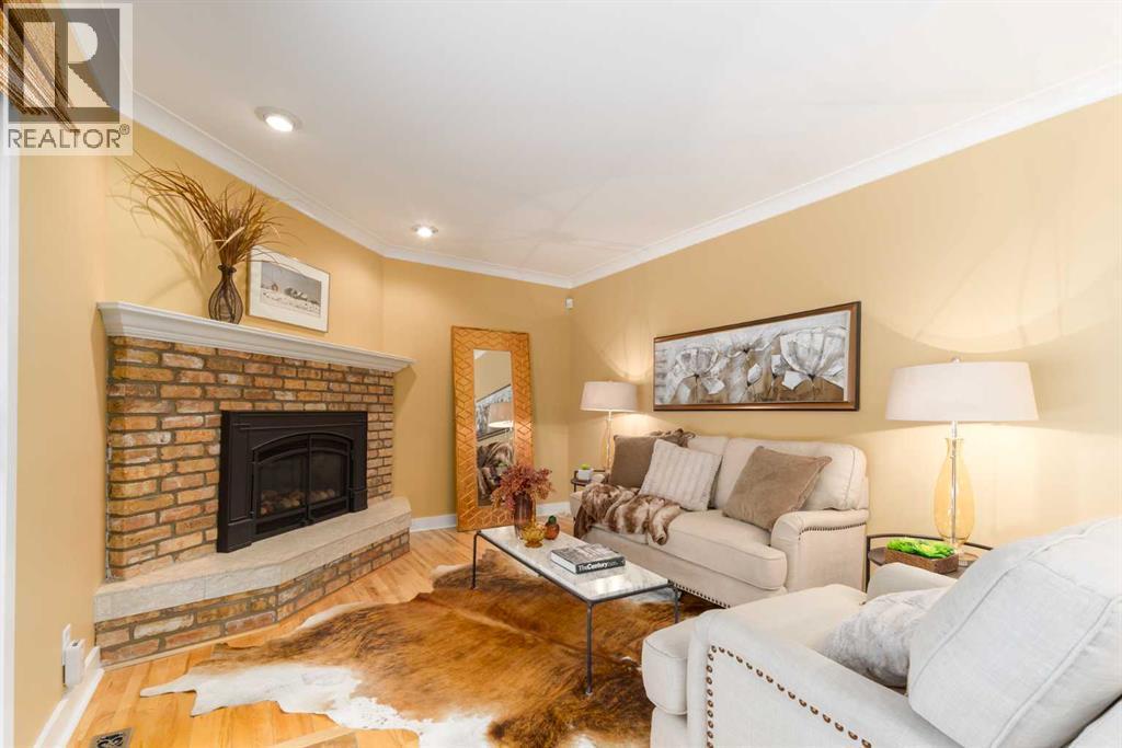 6701 Laird Court Sw, Calgary, AB - Indoor Photo Showing Living Room With Fireplace