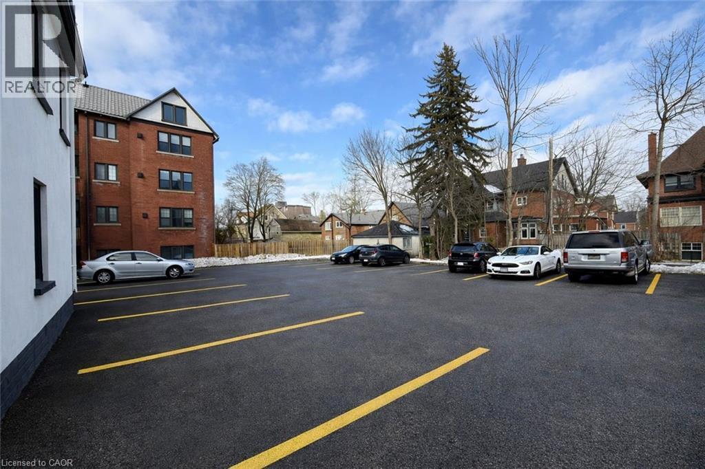Uncovered parking lot with a residential view - 44 Weber Street W, Kitchener, ON - Outdoor