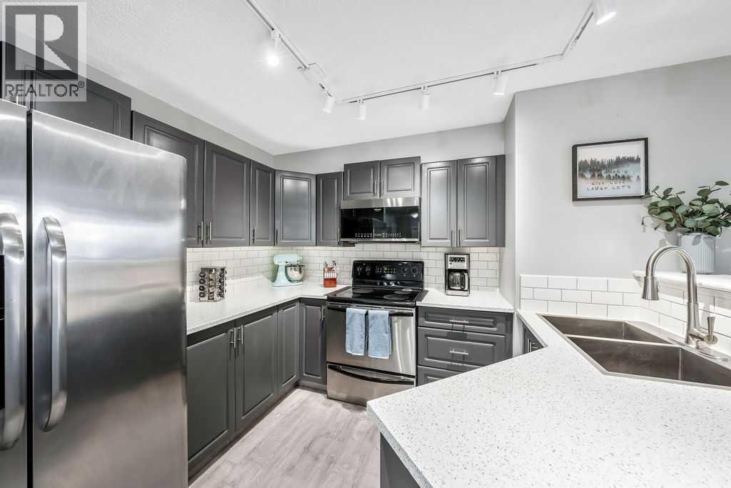 1120, 4975 130 Avenue Se, Calgary, AB - Indoor Photo Showing Kitchen With Stainless Steel Kitchen With Double Sink With Upgraded Kitchen