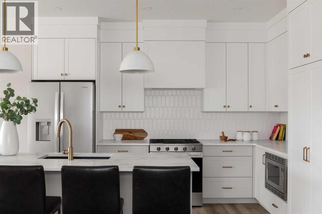 88 Sunrise Heath, Cochrane, AB - Indoor Photo Showing Kitchen With Upgraded Kitchen