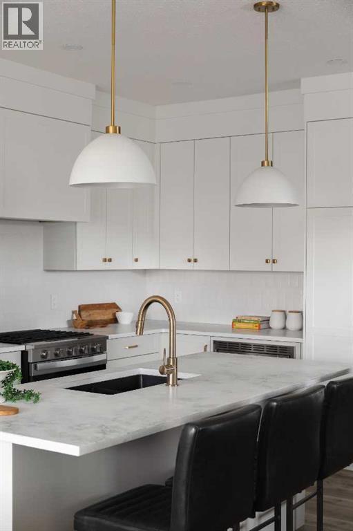 88 Sunrise Heath, Cochrane, AB - Indoor Photo Showing Kitchen With Upgraded Kitchen