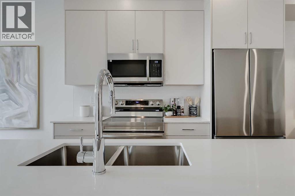 101, 3550 45 Street Sw, Calgary, AB - Indoor Photo Showing Kitchen With Stainless Steel Kitchen With Double Sink With Upgraded Kitchen