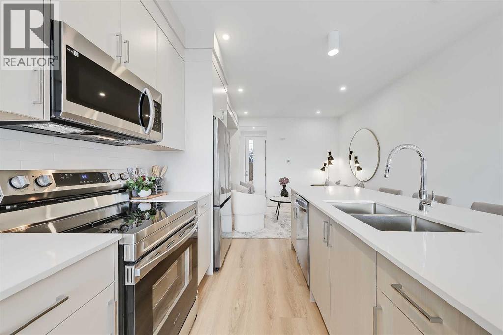 101, 3550 45 Street Sw, Calgary, AB - Indoor Photo Showing Kitchen With Stainless Steel Kitchen With Double Sink With Upgraded Kitchen