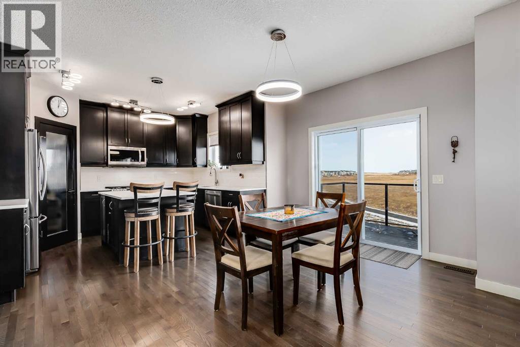 Notice Upgraded Light Fixtures - 382 Williamstown Green Nw, Airdrie, AB - Indoor Photo Showing Dining Room