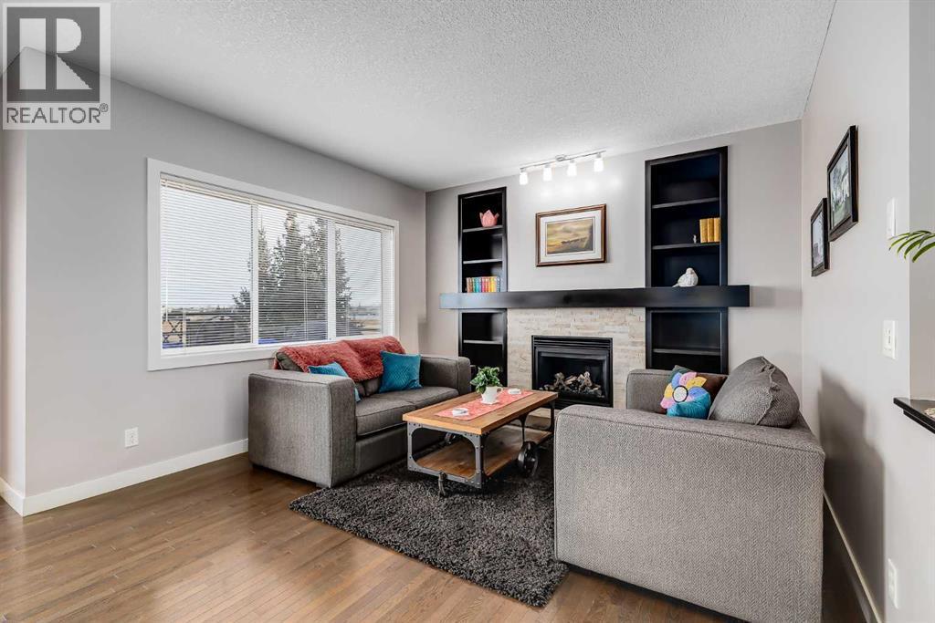 Main Living Room w/gas fireplace - 382 Williamstown Green Nw, Airdrie, AB - Indoor Photo Showing Living Room With Fireplace