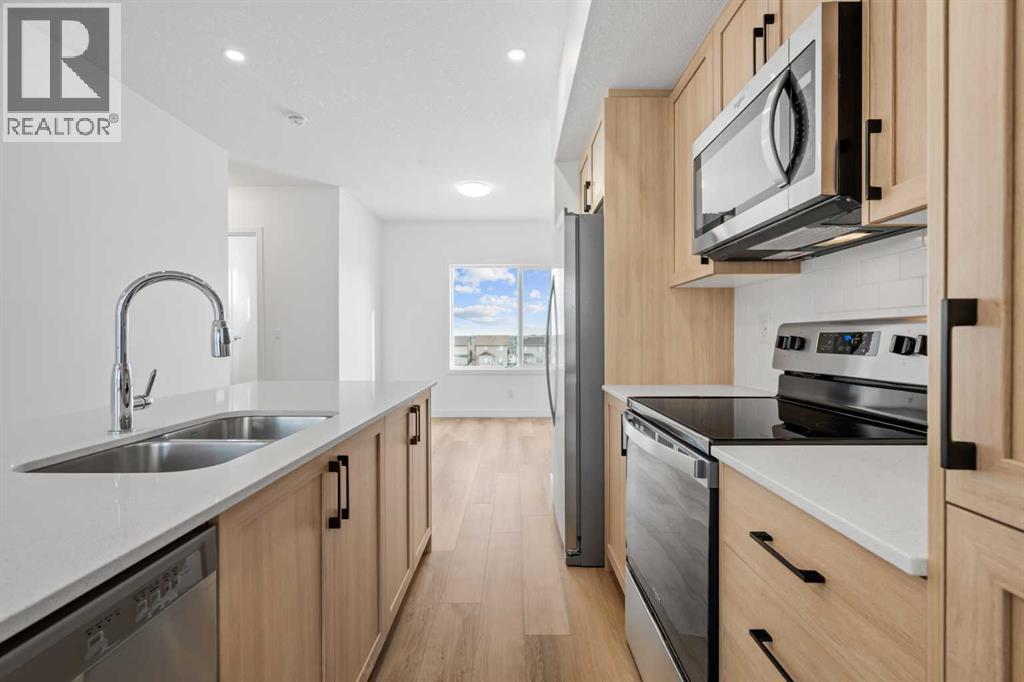 1506, 25 Wildwoods Court Sw, Airdrie, AB - Indoor Photo Showing Kitchen With Stainless Steel Kitchen With Double Sink
