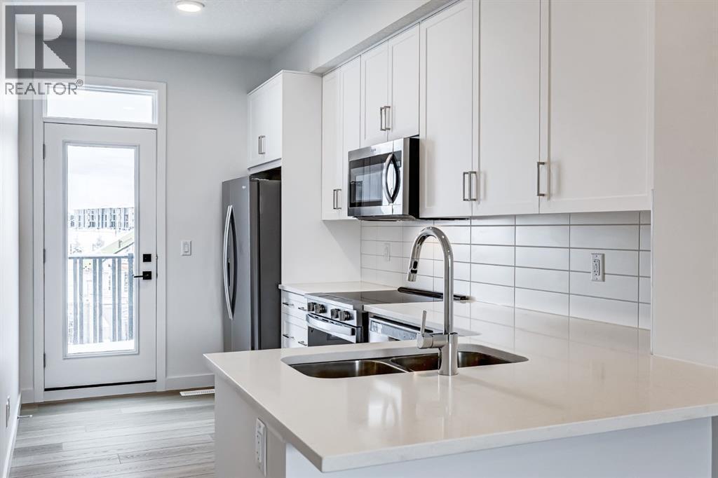 202, 437 Alpine Avenue Sw, Calgary, AB - Indoor Photo Showing Kitchen With Double Sink With Upgraded Kitchen