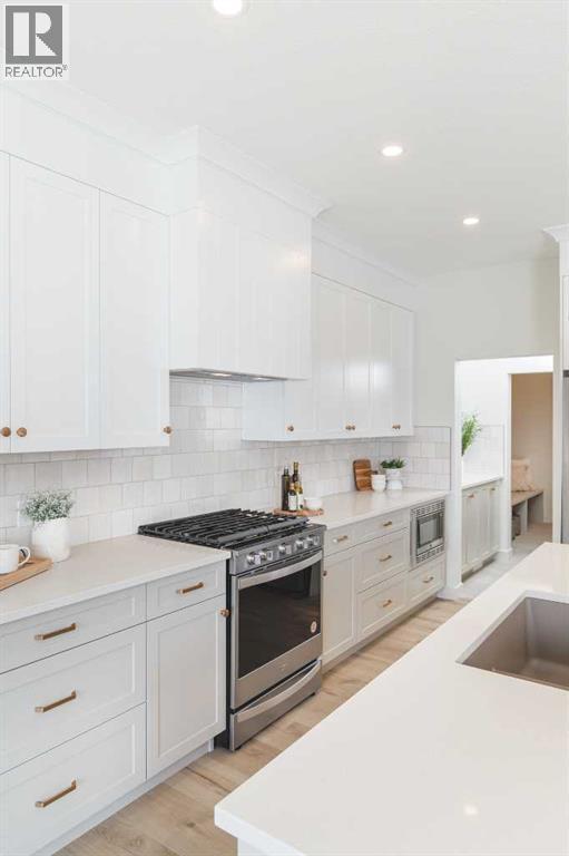 47 Sundown Crescent, Cochrane, AB - Indoor Photo Showing Kitchen With Upgraded Kitchen