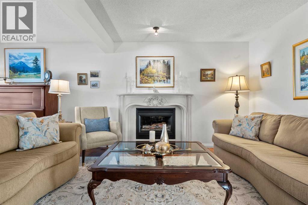 63 Springbank Crescent Sw, Calgary, AB - Indoor Photo Showing Living Room With Fireplace