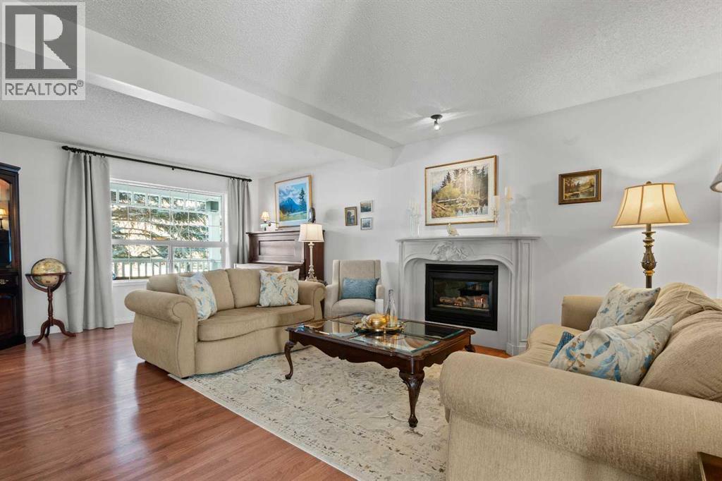 63 Springbank Crescent Sw, Calgary, AB - Indoor Photo Showing Living Room With Fireplace