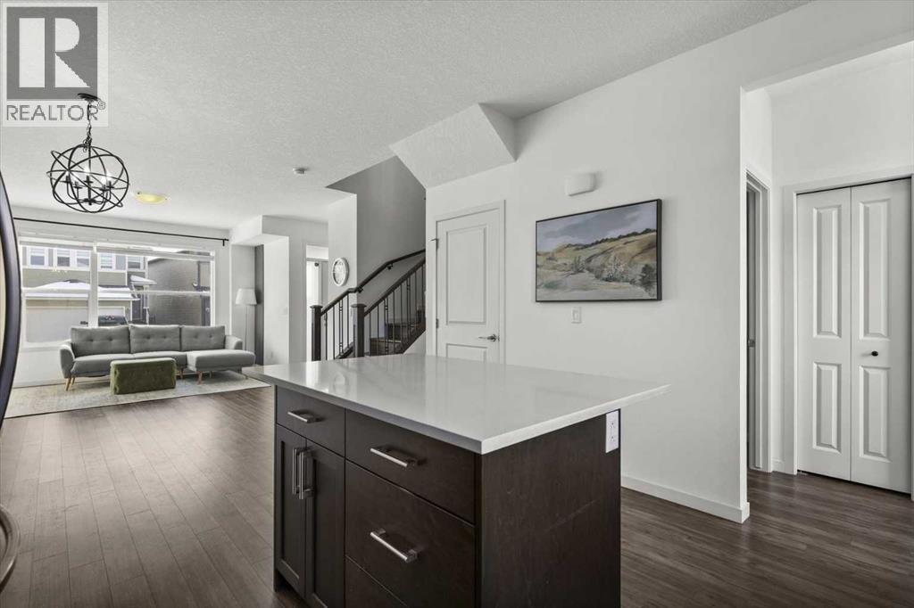 View of the dining space and the main level from the kitchen - 59 Wolf Hollow Way Se, Calgary, AB - Indoor