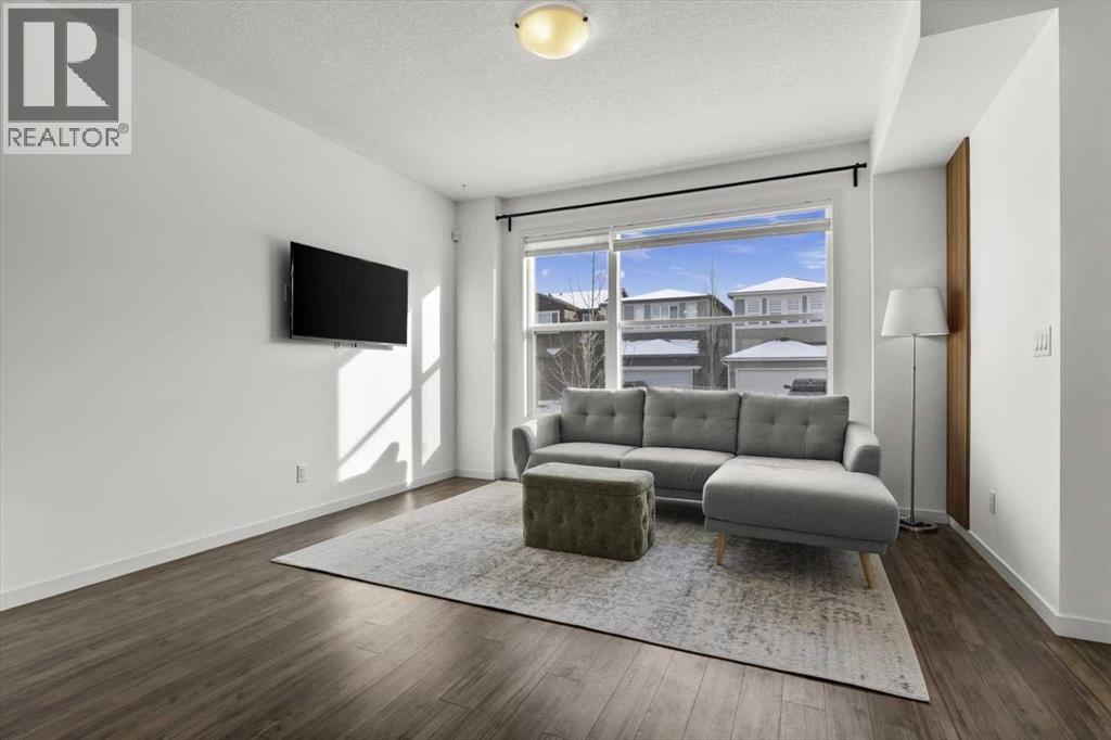 Unwind at the end of the day with family and friends.. - 59 Wolf Hollow Way Se, Calgary, AB - Indoor Photo Showing Living Room