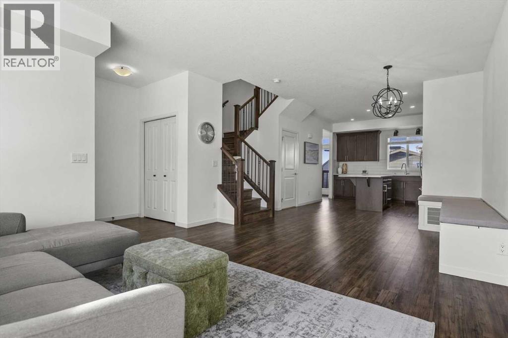 View of the sunny and spacious main level from the family room - 59 Wolf Hollow Way Se, Calgary, AB - Indoor Photo Showing Living Room