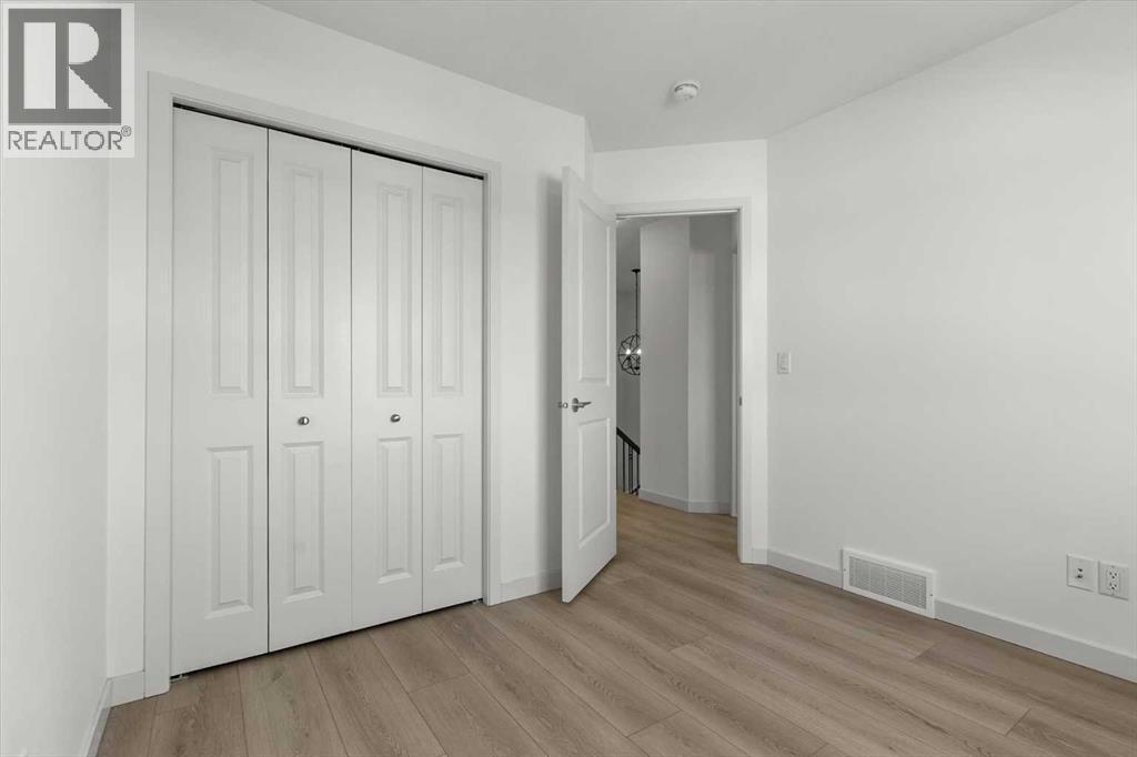 The vacant layout highlights the room’s adaptability and natural light - 59 Wolf Hollow Way Se, Calgary, AB - Indoor