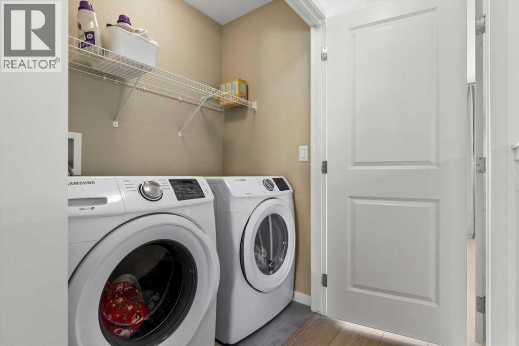A conveniently located upper-level laundry enhances day-to-day functionality - 59 Wolf Hollow Way Se, Calgary, AB - Indoor Photo Showing Laundry Room