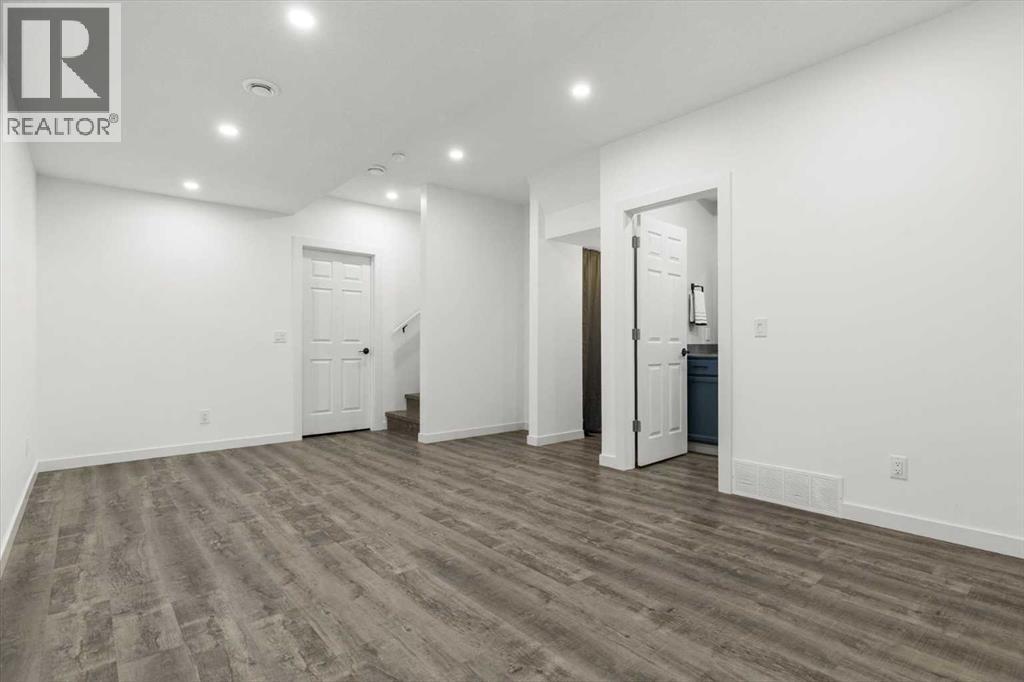 The fully developed lower level offers a bright, open layout ideal for a family room, media area, or flexible living space - 59 Wolf Hollow Way Se, Calgary, AB - Indoor Photo Showing Other Room