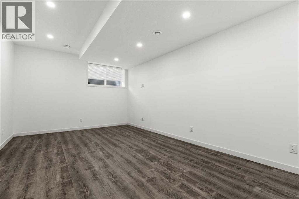 A spacious open area provides plenty of room to customize for recreation, work, or guests - 59 Wolf Hollow Way Se, Calgary, AB - Indoor Photo Showing Other Room