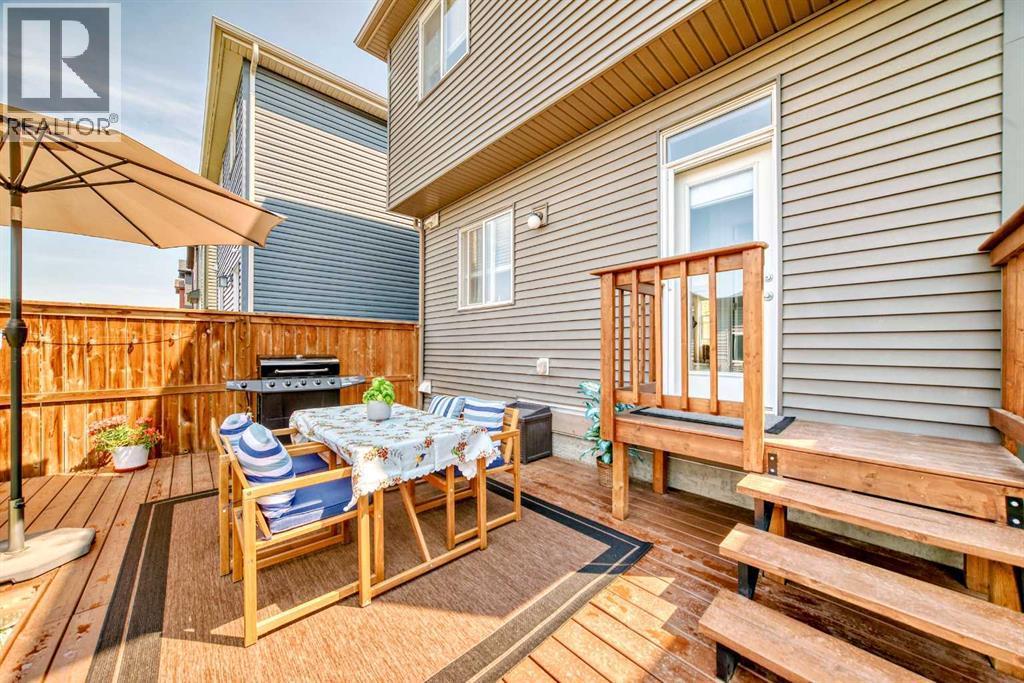 The combination of deck and lawn space provides flexibility for entertaining, play, or quiet evenings outdoors - 59 Wolf Hollow Way Se, Calgary, AB - Outdoor With Deck Patio Veranda With Exterior