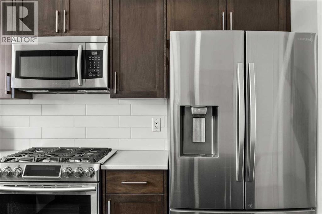 The premium stainless steel appliances highlight this kitchen package.. - 59 Wolf Hollow Way Se, Calgary, AB - Indoor Photo Showing Kitchen With Stainless Steel Kitchen With Upgraded Kitchen