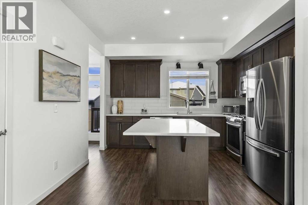 The dining nook seamlessly connects your guests to the kitchen - 59 Wolf Hollow Way Se, Calgary, AB - Indoor Photo Showing Kitchen With Stainless Steel Kitchen With Upgraded Kitchen