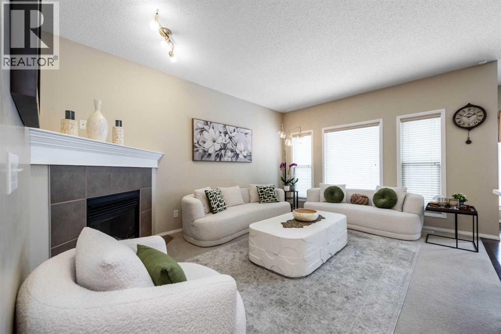 212 Silverado Range Heights Sw, Calgary, AB - Indoor Photo Showing Living Room With Fireplace