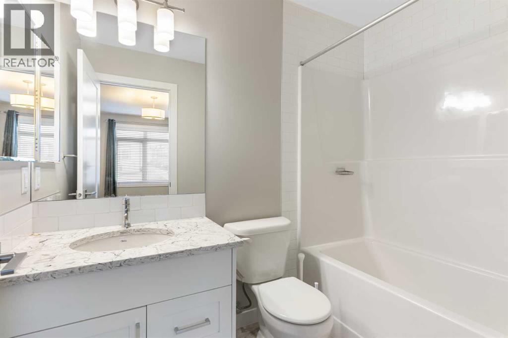 4-piece en-suite, comfort height elongated toilet, ceramic tile floor, granite counter - 217 Sage Bluff Drive Nw, Calgary, AB - Indoor Photo Showing Bathroom