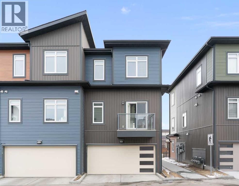Rear view, end unit, double attached garage, door opener., rear balcony - 217 Sage Bluff Drive Nw, Calgary, AB - Outdoor