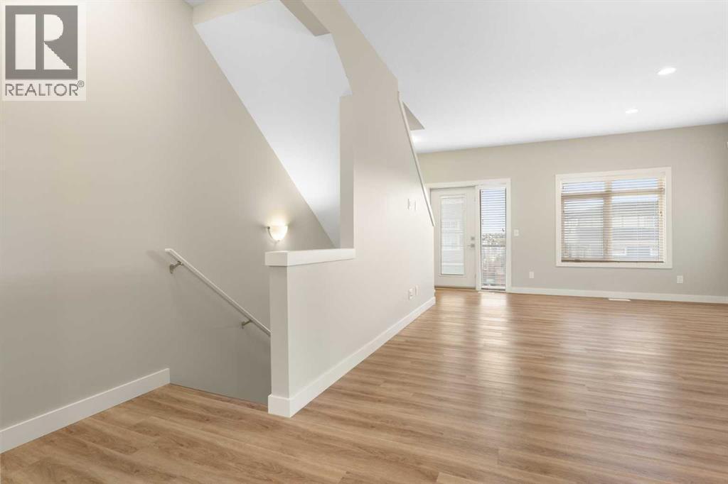 Main level, living room, luxury vinyl plank flooring. 9' knock down ceiling, - 217 Sage Bluff Drive Nw, Calgary, AB - Indoor Photo Showing Other Room