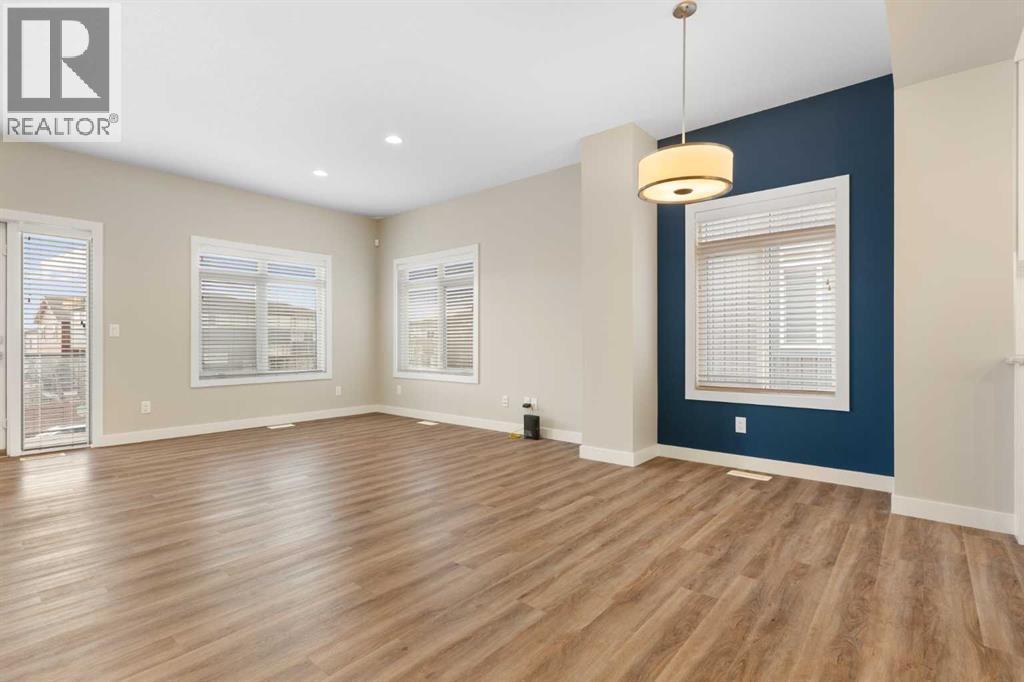 Living and dining room, lots of windows - 217 Sage Bluff Drive Nw, Calgary, AB - Indoor Photo Showing Other Room