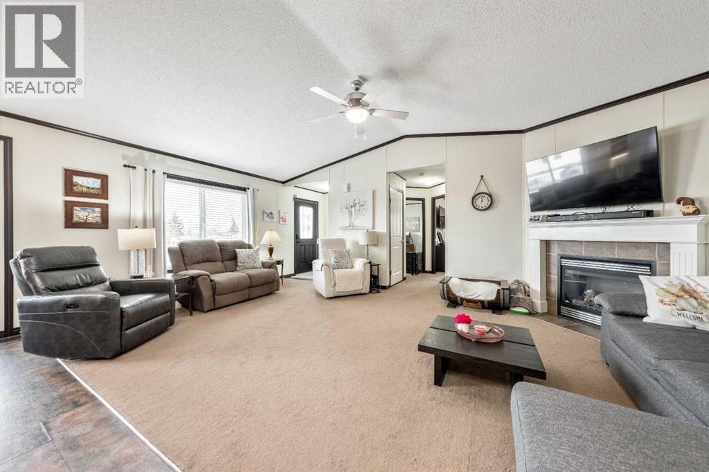 Open Concept Layout with Vaulted Ceilings - 4 Spring Dale Circle Se, Airdrie, AB - Indoor Photo Showing Living Room With Fireplace