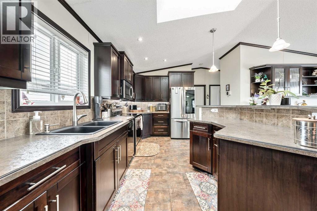 Beautifully UPDATED CHEF'S Kitchen - 4 Spring Dale Circle Se, Airdrie, AB - Indoor Photo Showing Kitchen With Double Sink With Upgraded Kitchen