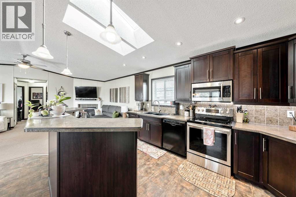 CHEF'S Kitchen w/ Skylight - 4 Spring Dale Circle Se, Airdrie, AB - Indoor Photo Showing Kitchen With Double Sink With Upgraded Kitchen
