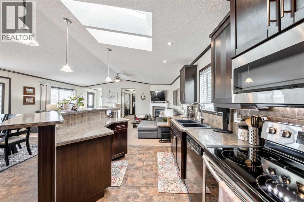 UPDATED Kitchen w/ STAINLESS STEEL Appliances & Rich Extended Height Cabinetry - 4 Spring Dale Circle Se, Airdrie, AB - Indoor Photo Showing Kitchen With Double Sink