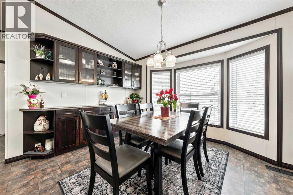 Beautiful Dining Area w/ Rich Cabinetry - 4 Spring Dale Circle Se, Airdrie, AB - Indoor Photo Showing Dining Room