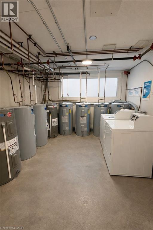 Below grade area with electric water heater and independent washer and dryer - 228 Margaret Avenue, Kitchener, ON - Indoor Photo Showing Laundry Room