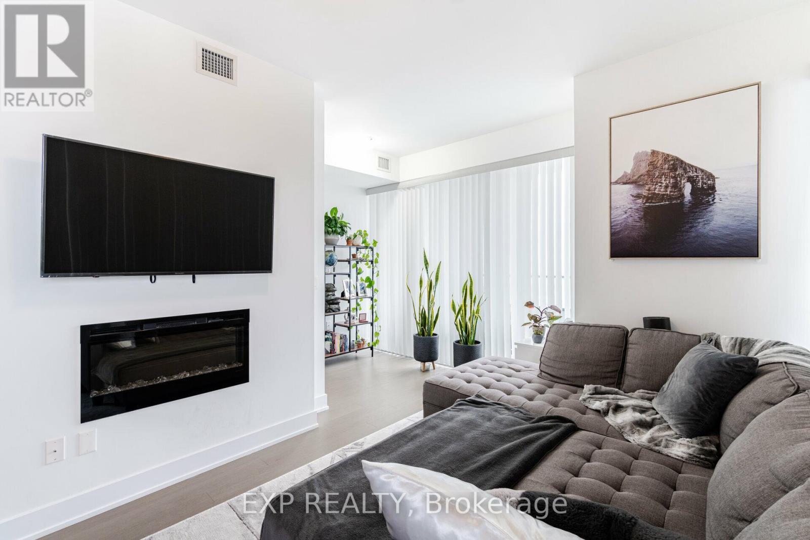 2221 - 30 Shore Breeze Drive, Toronto, ON - Indoor Photo Showing Living Room With Fireplace