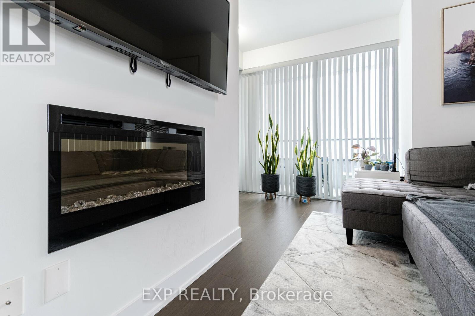 2221 - 30 Shore Breeze Drive, Toronto, ON - Indoor Photo Showing Living Room With Fireplace