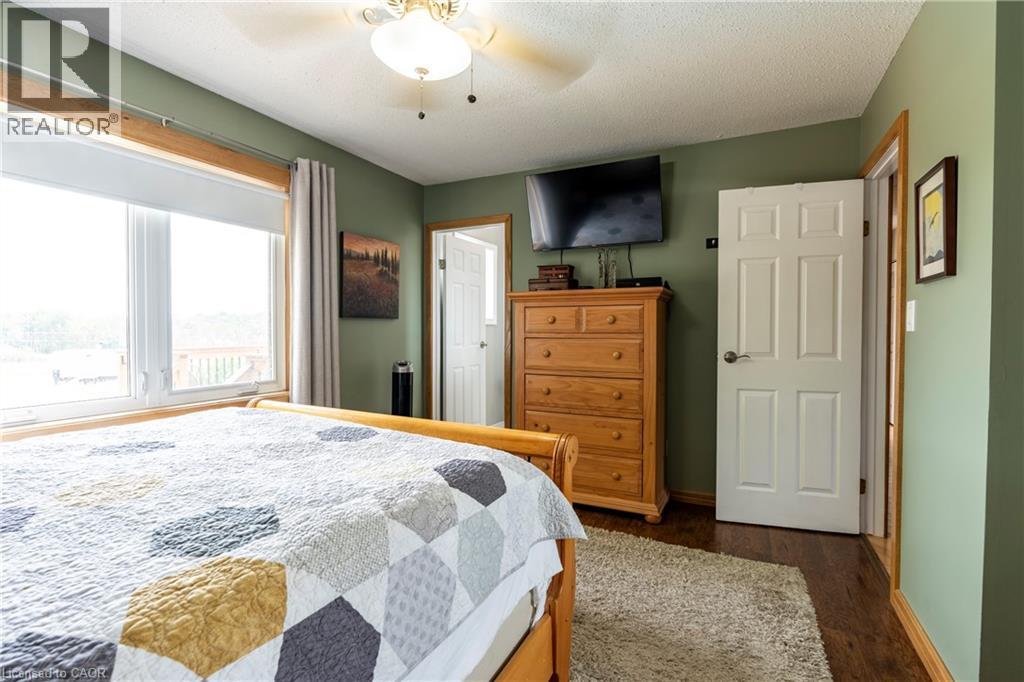 Bedroom featuring dark wood-style floors, ceiling fan, and a textured ceiling - 29 Armstrong Crescent, Grey Highlands, ON - Indoor Photo Showing Bedroom