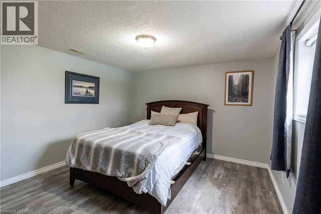 Bedroom with a textured ceiling and wood finished floors - 29 Armstrong Crescent, Grey Highlands, ON - Indoor Photo Showing Bedroom
