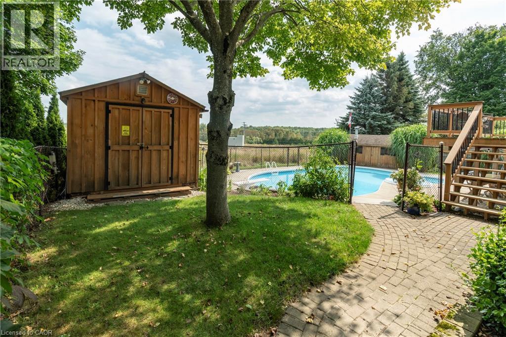 View of swimming pool featuring a storage unit, stairs, a patio area, and a fenced backyard - 29 Armstrong Crescent, Grey Highlands, ON - Outdoor With In Ground Pool With Backyard
