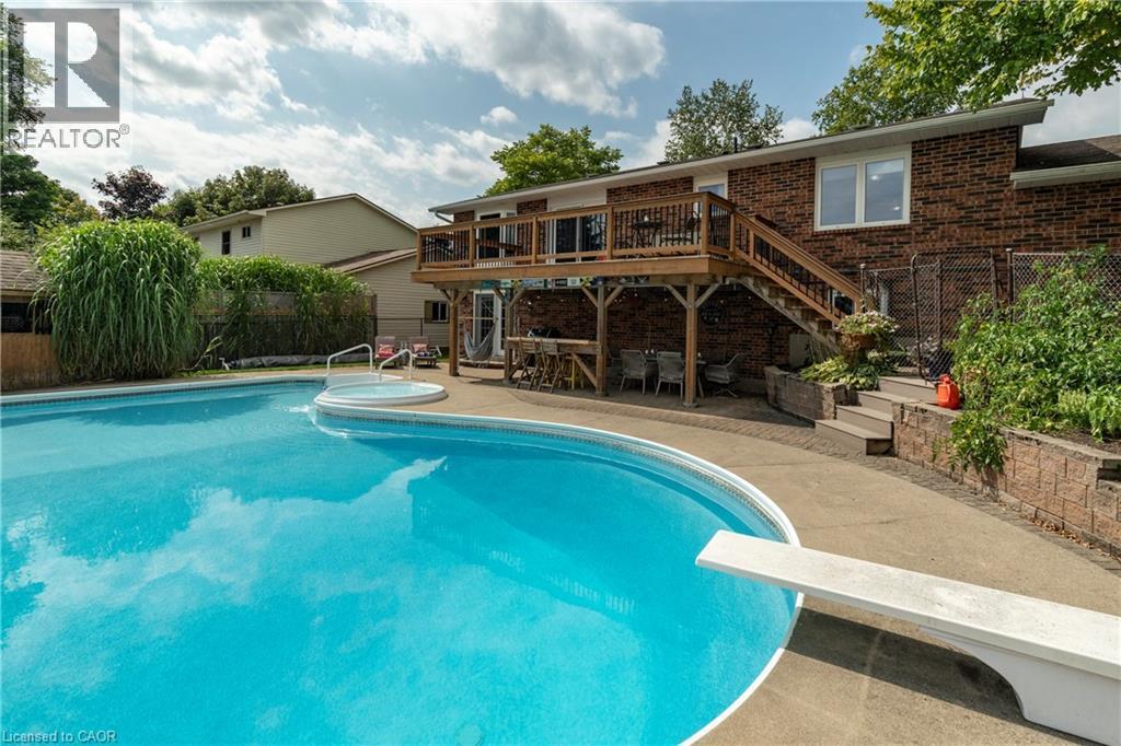 View of swimming pool featuring stairs, a patio area, a fenced backyard, a wooden deck, and a diving board - 29 Armstrong Crescent, Grey Highlands, ON - Outdoor With In Ground Pool With Deck Patio Veranda
