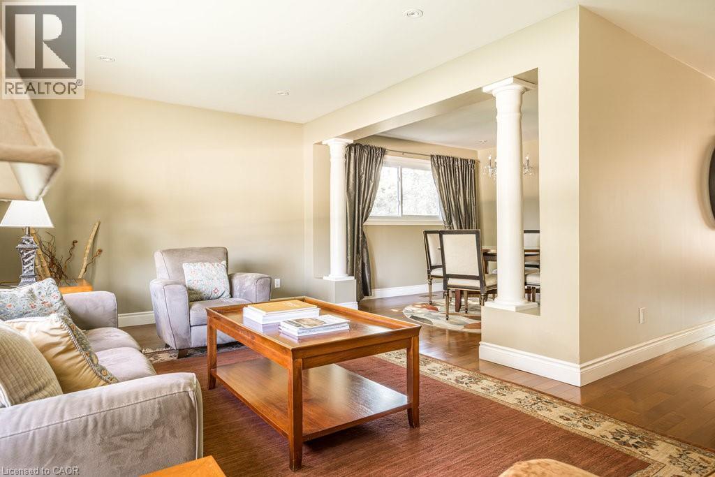 Living area with decorative columns, baseboards, and wood finished floors - 330 Strathcona Drive, Burlington, ON - Indoor Photo Showing Living Room