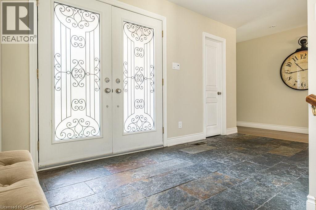 Foyer entrance with stone tile floors and baseboards - 330 Strathcona Drive, Burlington, ON - Indoor Photo Showing Other Room