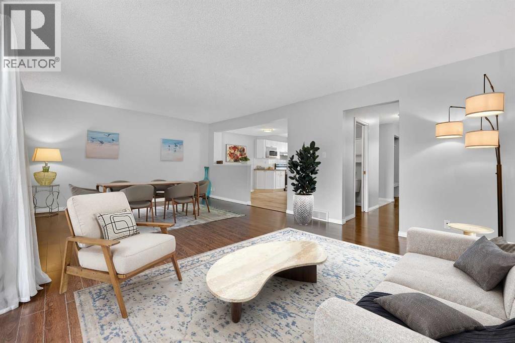 Virtually Staged - 115, 4810 40 Avenue Sw, Calgary, AB - Indoor Photo Showing Living Room