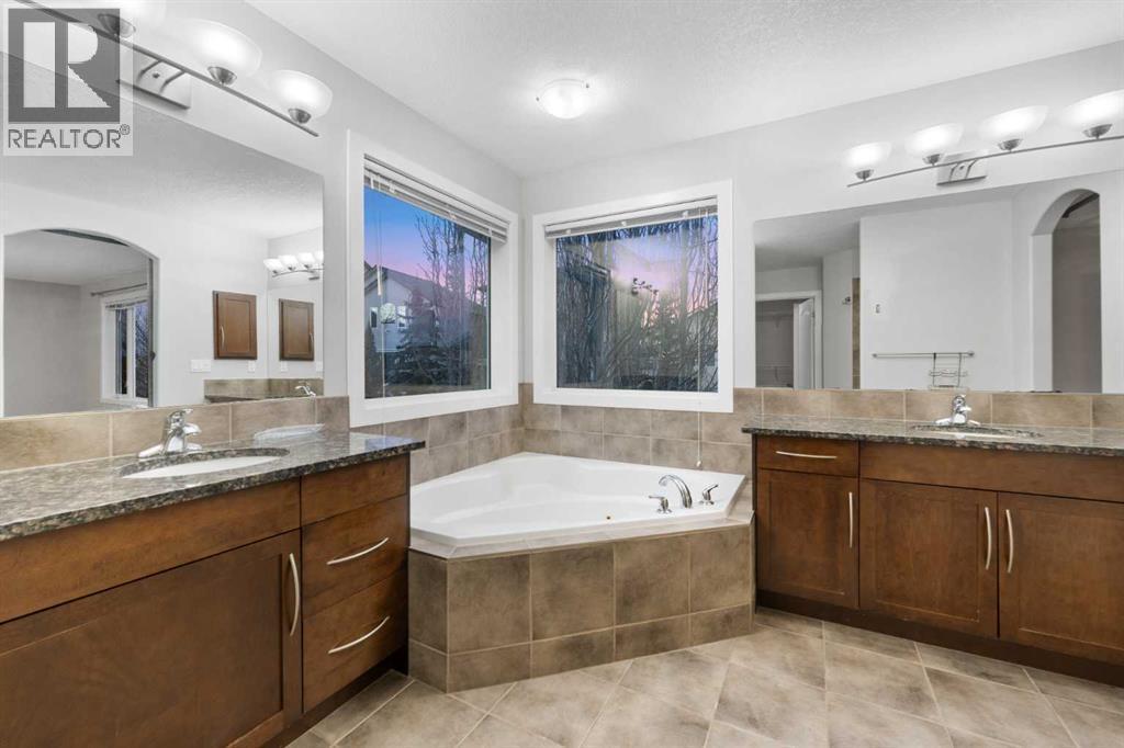 Well-appointed 5-piece ensuite with his-and-hers sinks. - 70 Royal Ridge Manor Nw, Calgary, AB - Indoor Photo Showing Bathroom