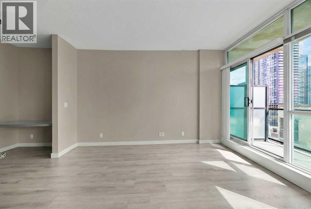 Bright and Spacious Living Room with Patio Doors to Balcony - 701, 788 12 Avenue Sw, Calgary, AB - Indoor Photo Showing Other Room